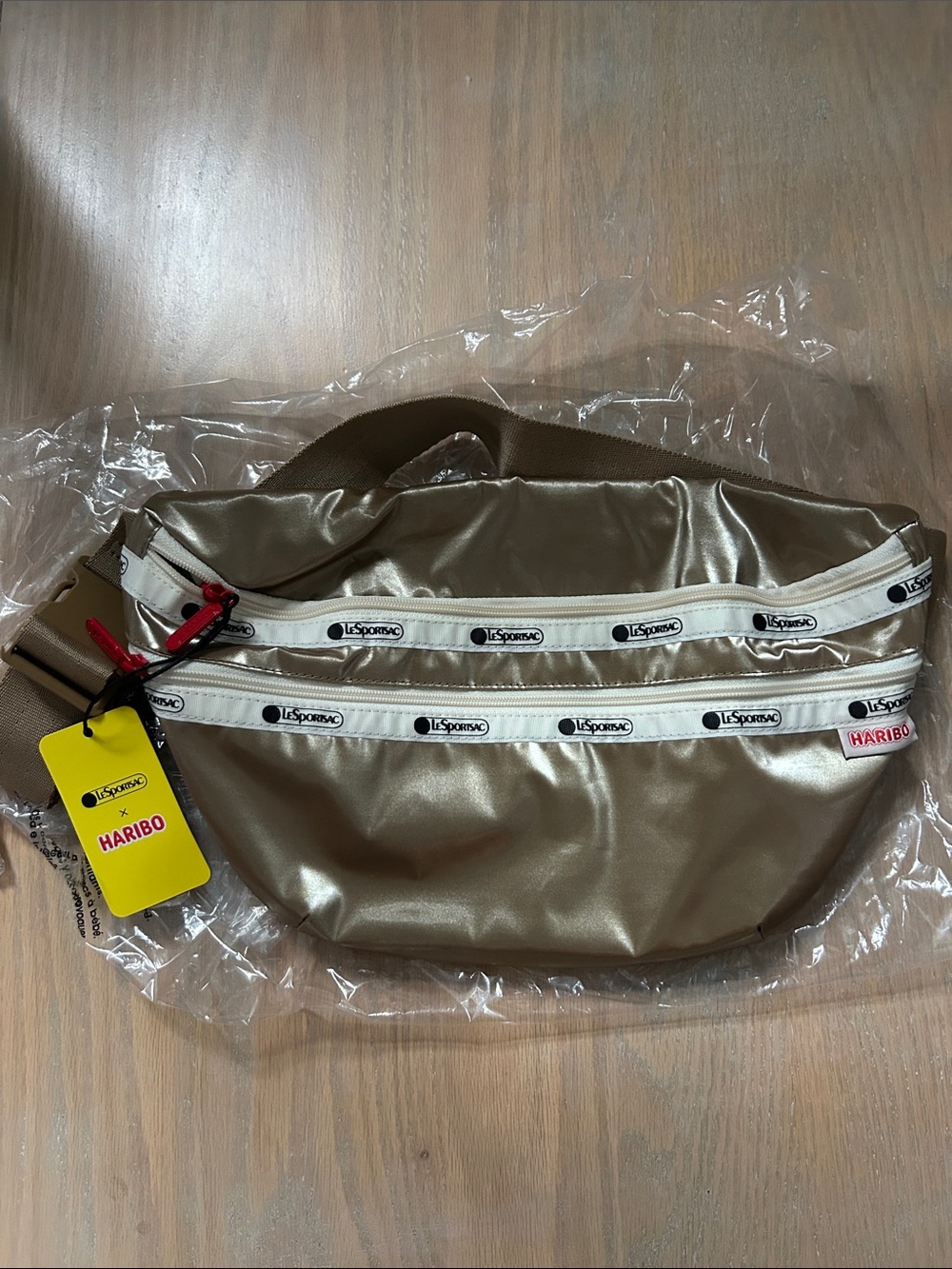 Lesportsac Metallic Gold Crossbody Belt Bag with White Trim and Red Zipper Pulls